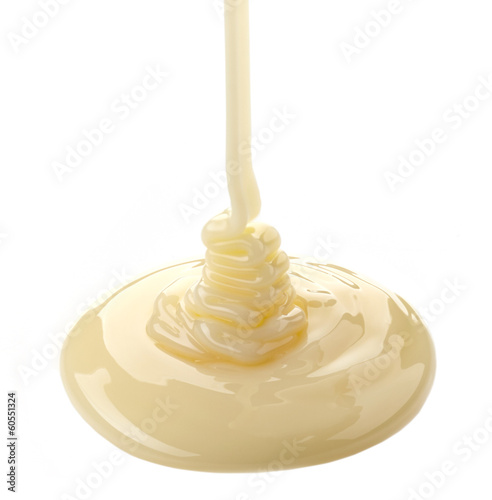 pouring condensed milk on a white background