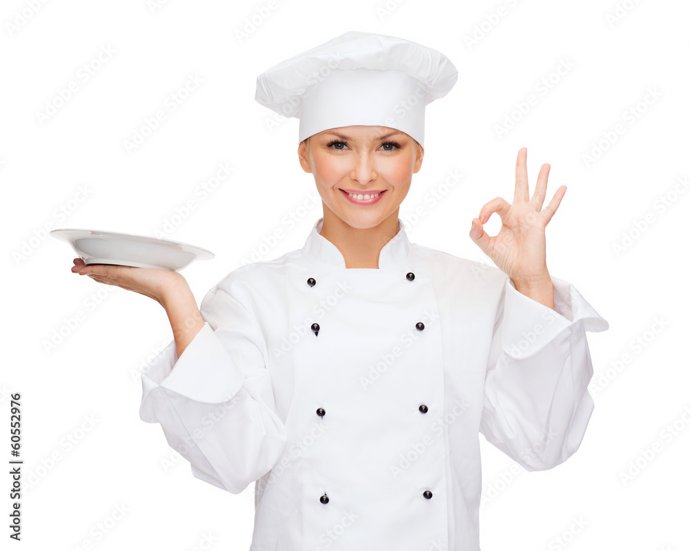 female chef with empty plate showing ok sign female chef with empty plate showing ok sign