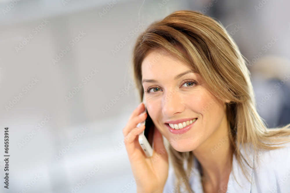 Smiling businesswoman talking on mobile phone Smiling businesswoman talking on mobile phone