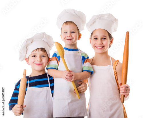 Three young chefs with ladle and rolling pin