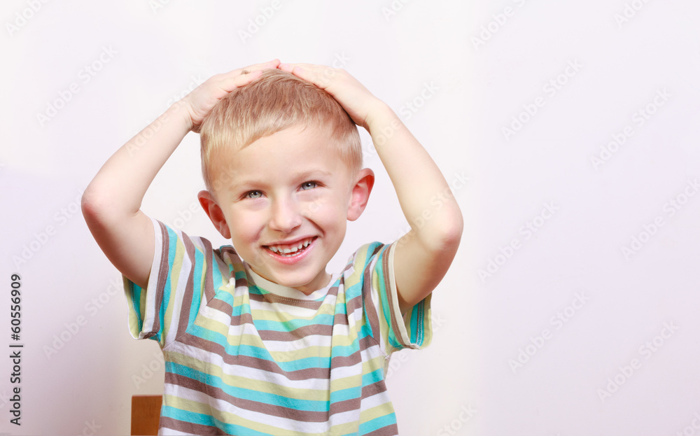 Portrait of surprised emotional blond boy child kid at the table Portrait of surprised emotional blond boy child kid at the table