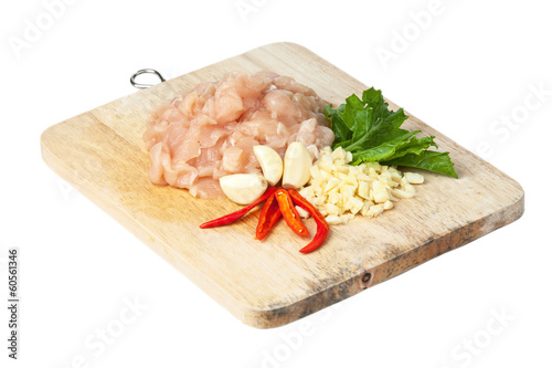 raw chicken meat on cutting board, isolated on white photo