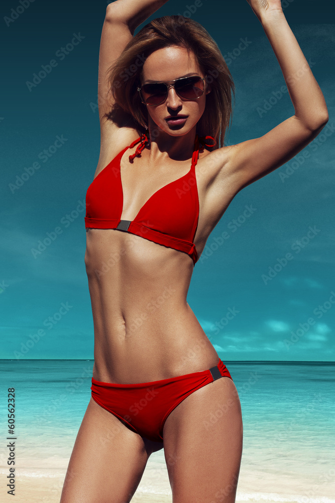 Beautiful girl posing on the beach in the hot sun, outdoor portr