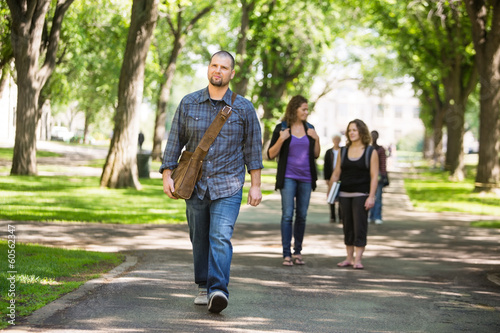 Confident Male Grad Student Walking On Campus