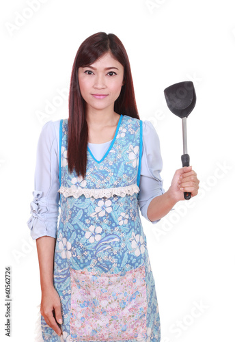 female chef with spade of frying pan