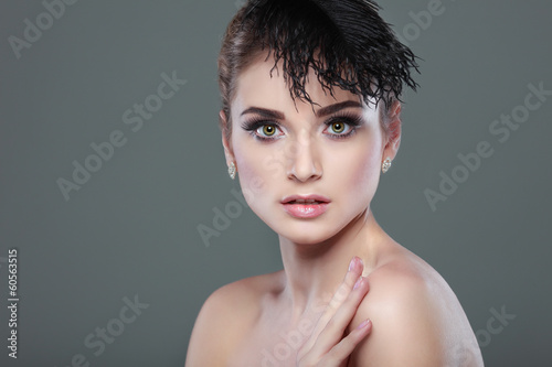 portrait whiteheaded young woman with black feather on grey 