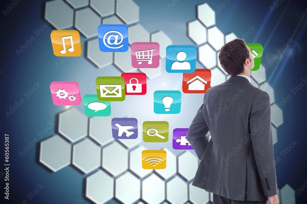 Composite image of businessman standing with hand on hip Composite image of businessman standing with hand on hip