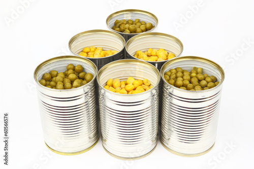 The tins with peas, corn on the white background