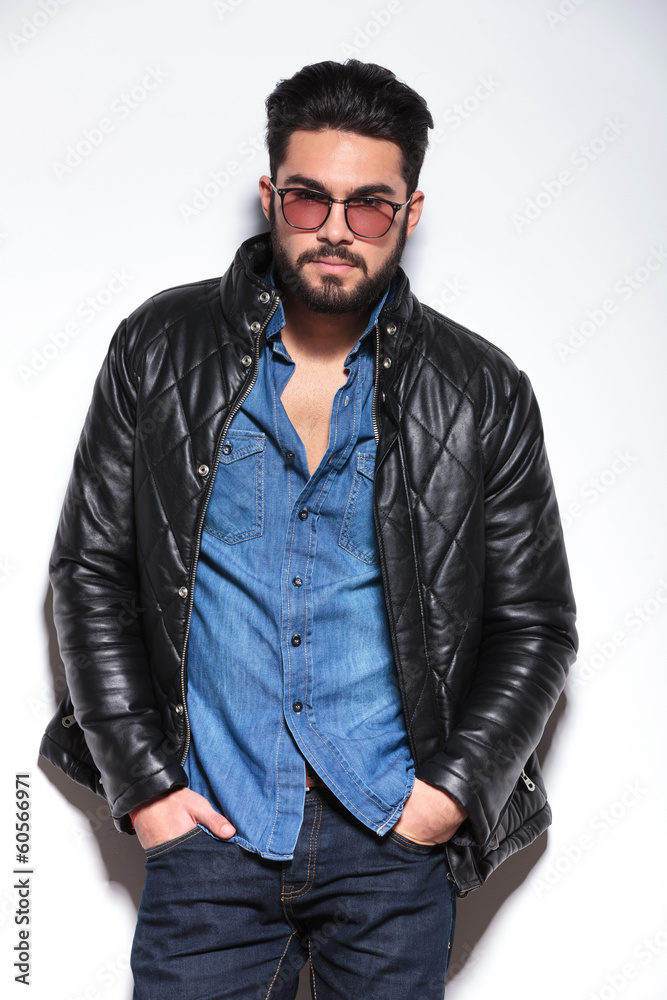 fashion man with glasses and leather jacket posing