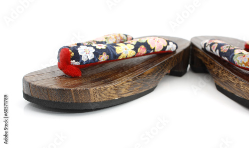Wooden sandals over white background