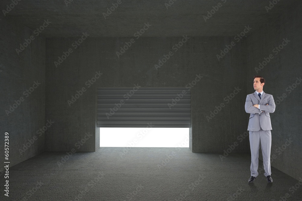 Obraz premium Composite image of serious businessman with arms crossed