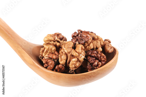 Wooden spoon full with walnuts.
