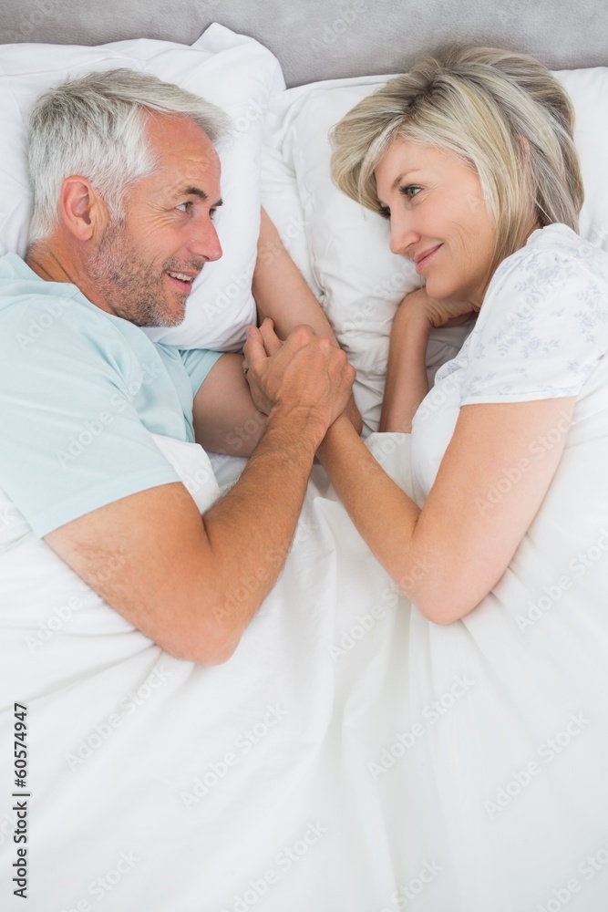 Loving mature man and woman lying in bed Loving mature man and woman lying in bed