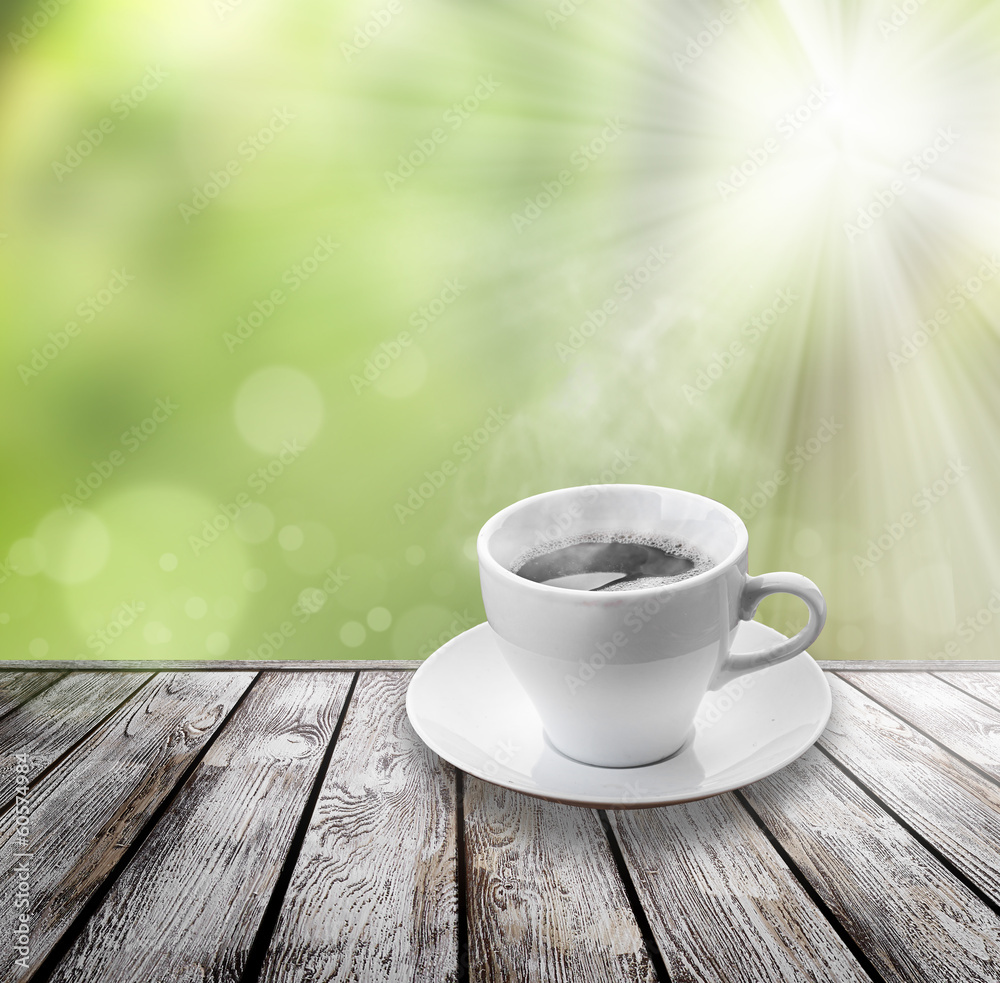 coffee on wood floor with green bokeh . coffee on wood floor with green bokeh .
