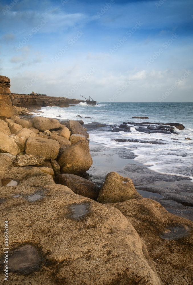 Landscape of waves crashing onto rocks during beautiful Winter's Landscape of waves crashing onto rocks during beautiful Winter's
