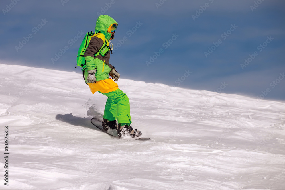Snowboarder doing a toe side carve Snowboarder doing a toe side carve
