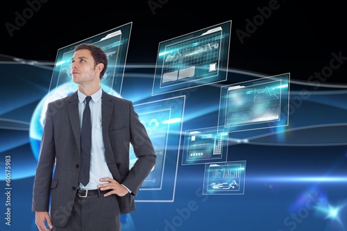 Wallpaper Mural Composite image of serious businessman with hand on hip Torontodigital.ca