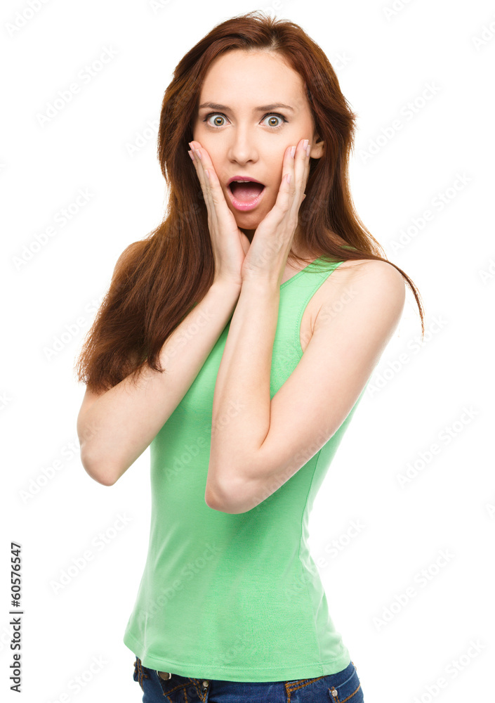 Woman is holding her face in astonishment Woman is holding her face in astonishment