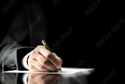 Businessman signing a document photo