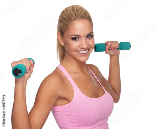 Beautiful young female exercising with dumbells