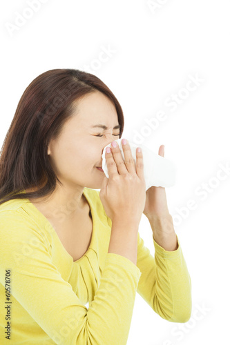 young woman using a tissue and blowing nose