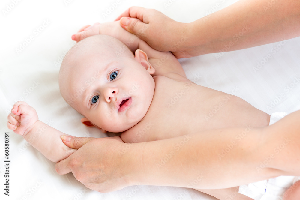 doctor or mother does gymnastics to baby doctor or mother does gymnastics to baby