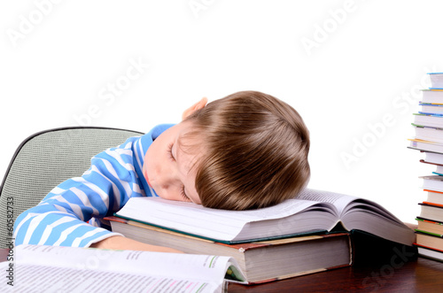 boy sleeping on a books