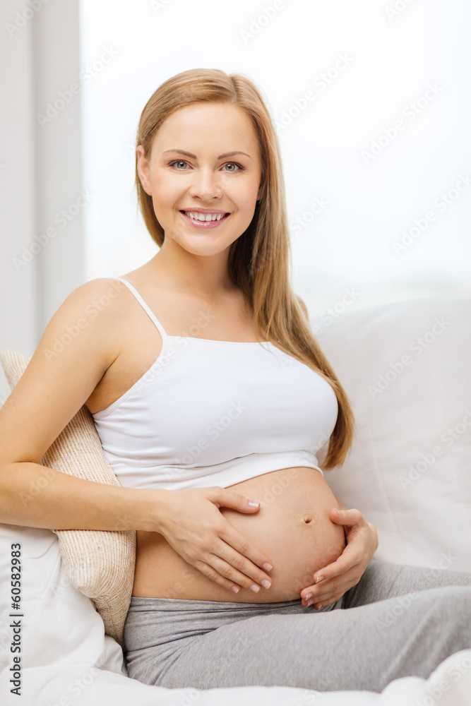 happy pregnant woman touching her belly happy pregnant woman touching her belly