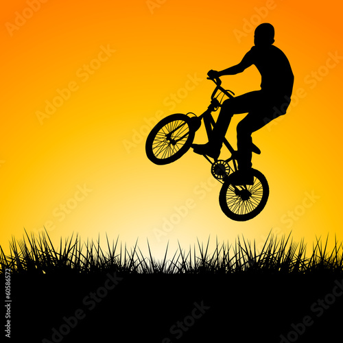 Silhouette of a biker jumping in the sunset