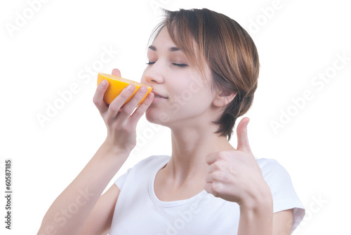 Girl sniffing half of grapefruit