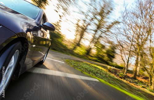Front side view of speeding car.