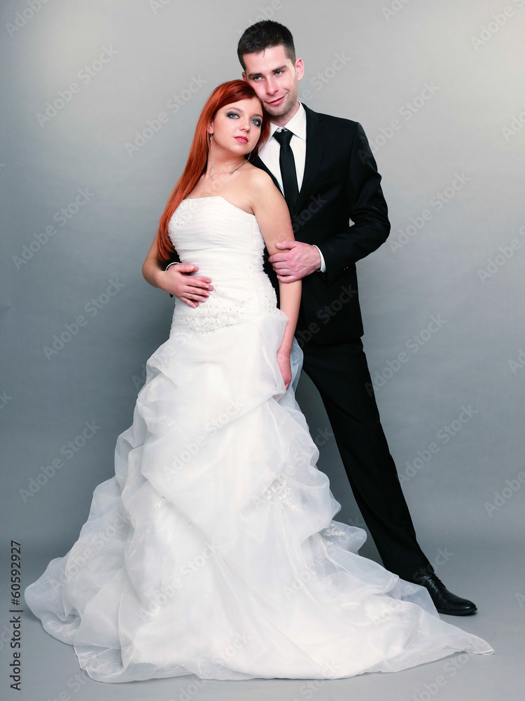 Happy married couple bride groom on gray background