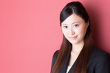 young asian businesswoman on red background