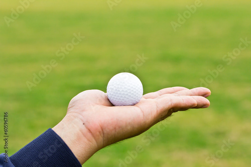 Close up golf ball on hand