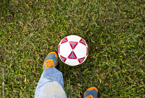 soccer ball with feet on the football field