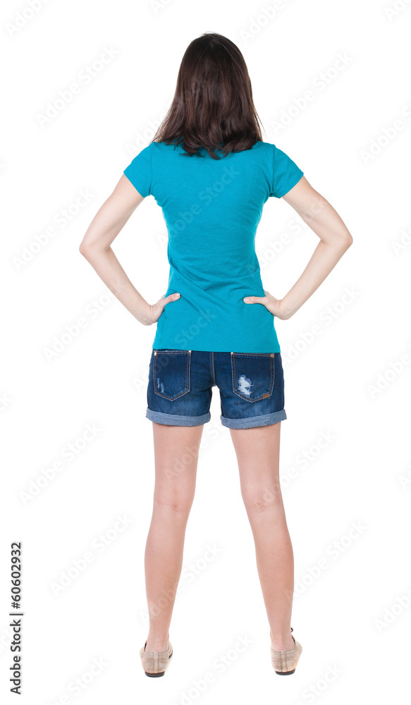 back view of standing young beautiful brunette woman in shorts. back view of standing young beautiful brunette woman in shorts.