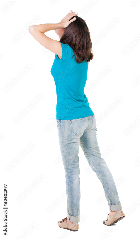 Back view of shocked woman in blue jeans Back view of shocked woman in blue jeans