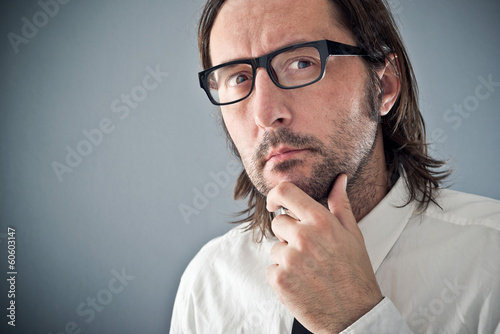 Businessman thinking, portrait with copy space photo
