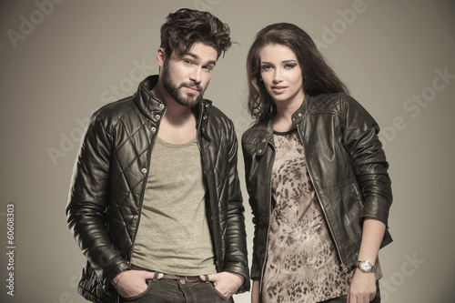 modern couple in leather clothes standing next to each