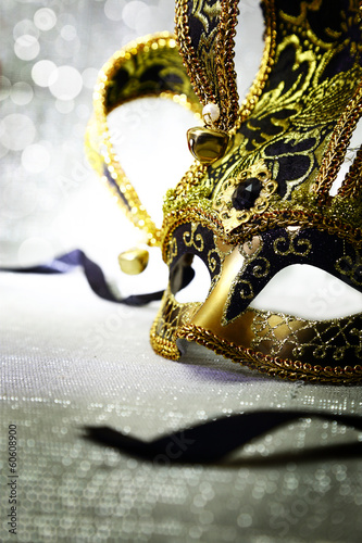 Vintage venetian carnival mask with glittering background