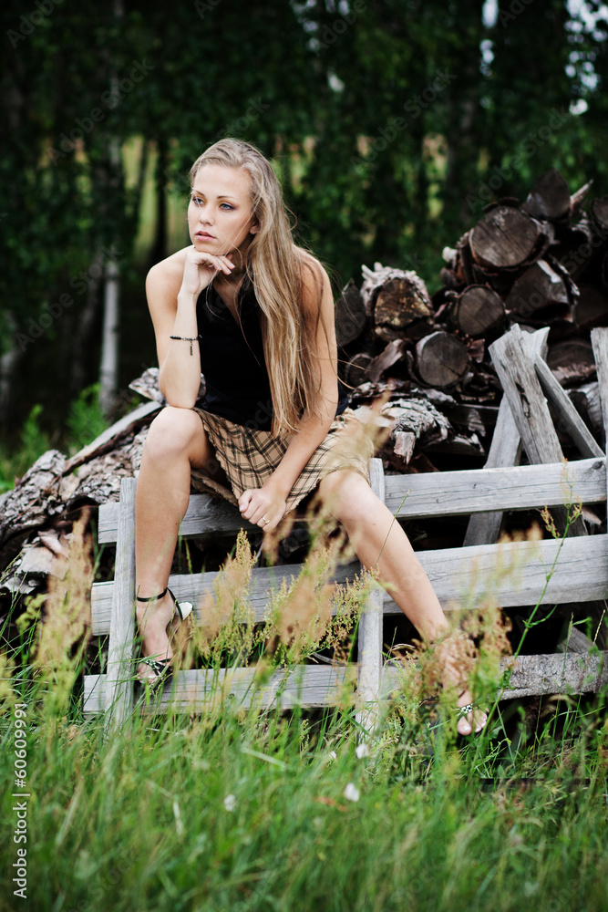 The resting young girl in the woods. Long hair dispelled by wind The resting young girl in the woods. Long hair dispelled by wind