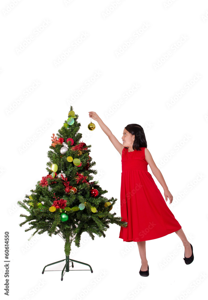 little girl decorating a Christmas tree