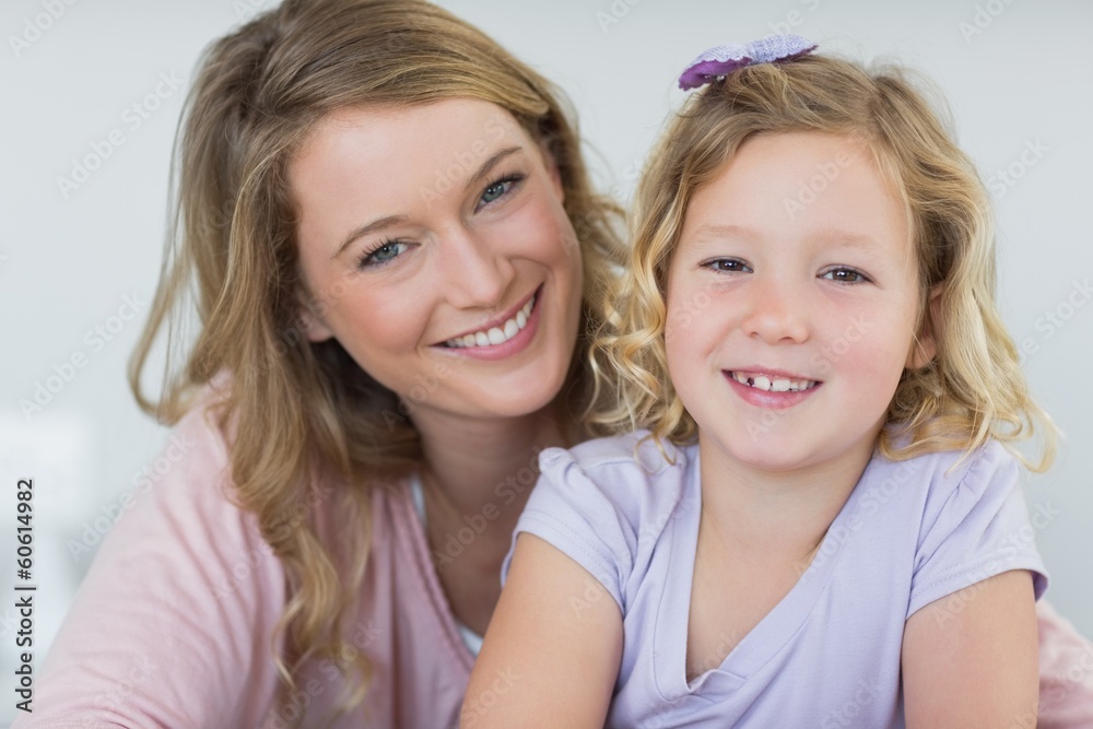 Girl and mother smiling together at home Girl and mother smiling together at home