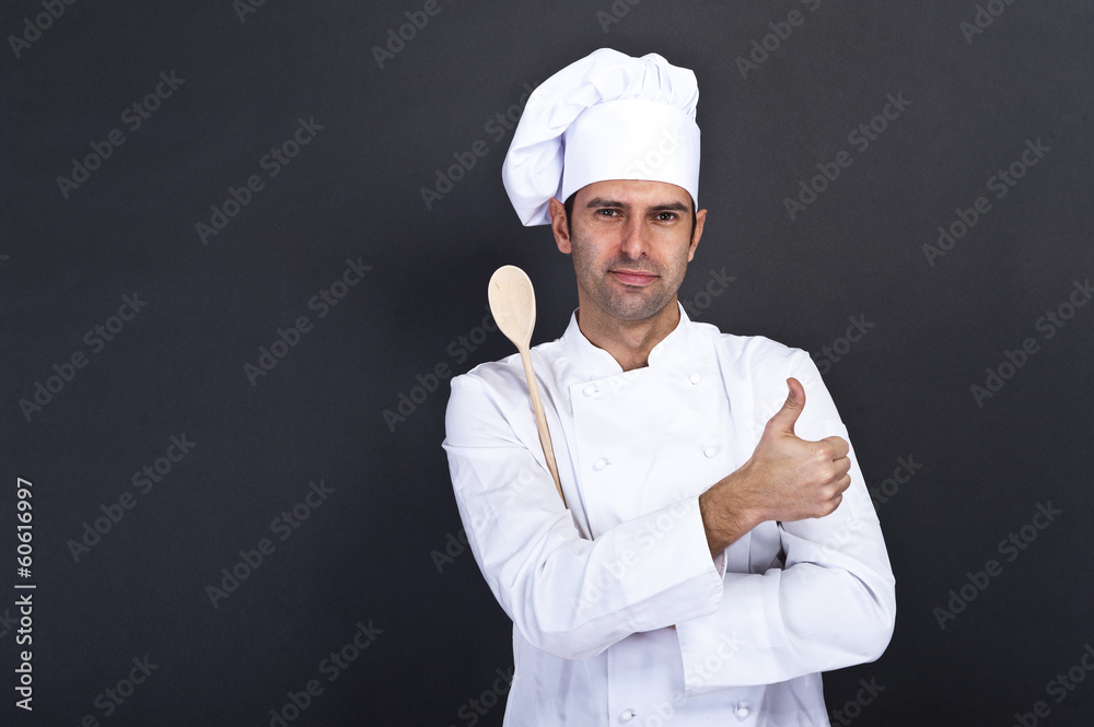 portriat of the cook with spoon over dark background portriat of the cook with spoon over dark background