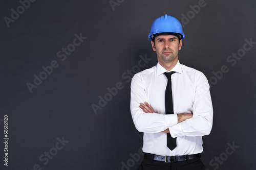 Young construction worker in hard hat on gray backgroundStock Ph photo