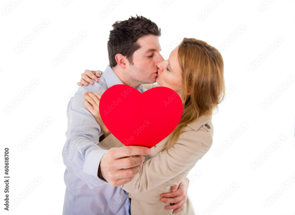love heart with a young couple kissing in back ground love heart with a young couple kissing in back ground