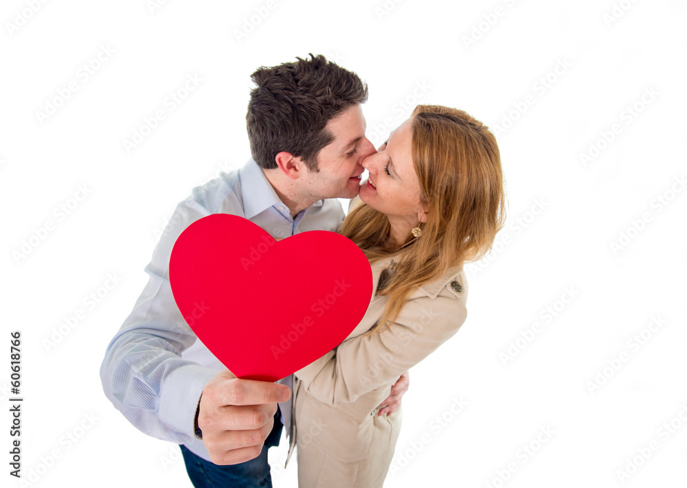 love heart with a young couple kissing in back ground