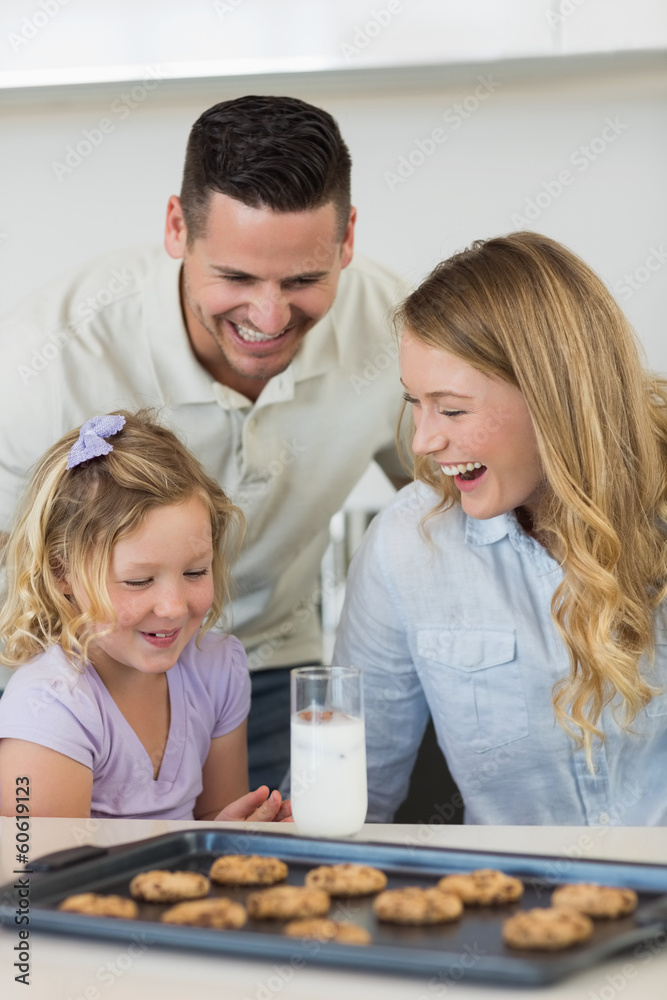 Family with milk and cookies at counter