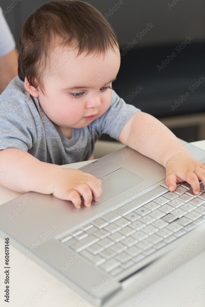 Baby using laptop at table Baby using laptop at table