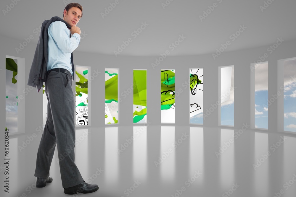 Fototapeta premium Composite image of serious businessman holding his jacket